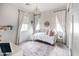 Bright bedroom with a crib, chandelier, large windows and neutral tones at 3927 E Sheila Ln, Phoenix, AZ 85018