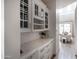 Elegant butler's pantry features custom cabinets, wine storage, and marble countertops, connecting to a bright living space at 3927 E Sheila Ln, Phoenix, AZ 85018
