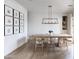 Bright dining room featuring a long table, minimalist light fixture, and Gathering photos on the wall at 3927 E Sheila Ln, Phoenix, AZ 85018
