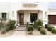 Inviting covered front porch with brick steps, chairs and lush landscaping at 3927 E Sheila Ln, Phoenix, AZ 85018