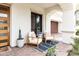 Inviting front porch with comfortable seating, potted plants, and a modern front door at 3927 E Sheila Ln, Phoenix, AZ 85018