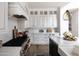 Kitchen area with marble countertops, white cabinetry, and stainless steel appliances at 3927 E Sheila Ln, Phoenix, AZ 85018