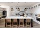 Bright kitchen showcases a large island, marble countertops, pendant lights, and white cabinetry at 3927 E Sheila Ln, Phoenix, AZ 85018