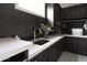 Beautiful laundry room with dark cabinets, white countertops, stylish fixtures, and decorative accents at 3927 E Sheila Ln, Phoenix, AZ 85018