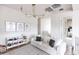 Bright loft area with floral wallpaper, modern chandelier, white sofa and display cabinet at 3927 E Sheila Ln, Phoenix, AZ 85018