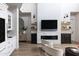Open living area with a fireplace, white cabinetry, and modern furnishings at 3927 E Sheila Ln, Phoenix, AZ 85018