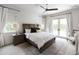 Inviting primary bedroom with a wooden-framed bed, neutral tones, and a ceiling fan at 3927 E Sheila Ln, Phoenix, AZ 85018