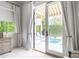 Sunlit bedroom with French doors opening to a view of a private backyard pool and lounge area at 3927 E Sheila Ln, Phoenix, AZ 85018