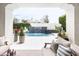 Picturesque view through the loggia to the backyard pool, showcasing a cascading water feature at 3927 E Sheila Ln, Phoenix, AZ 85018
