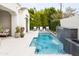 Sparkling pool features an elegant stacked stone water feature with lounge seating and privacy landscaping at 3927 E Sheila Ln, Phoenix, AZ 85018