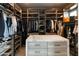 Expansive walk-in closet features custom shelving and a marble countertop island at 3927 E Sheila Ln, Phoenix, AZ 85018