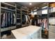 Spacious walk-in closet featuring custom shelving, cabinets, and storage solutions at 3927 E Sheila Ln, Phoenix, AZ 85018