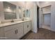 Bathroom features a dual sink vanity with white cabinets and quartz countertop at 4521 S 95Th Dr, Tolleson, AZ 85353