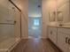 Bathroom features a glass shower, dual vanity, and view into bedroom at 4521 S 95Th Dr, Tolleson, AZ 85353
