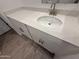 Bathroom vanity featuring white cabinets and granite countertops and a brushed steel faucet at 4521 S 95Th Dr, Tolleson, AZ 85353