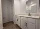 Bathroom with white cabinets, wood-look flooring, and a view into the bath and shower at 4521 S 95Th Dr, Tolleson, AZ 85353