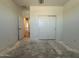 Bedroom showcasing a sliding-door closet with a view of the living area at 4521 S 95Th Dr, Tolleson, AZ 85353