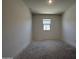 Bright bedroom with a window offering natural light and blank canvas flooring at 4521 S 95Th Dr, Tolleson, AZ 85353