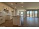 An open kitchen and living area with white cabinets, granite countertops, stainless steel appliances, and tile floors at 4521 S 95Th Dr, Tolleson, AZ 85353