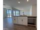 A kitchen island with white cabinets, granite countertops, and a stainless steel sink at 4521 S 95Th Dr, Tolleson, AZ 85353