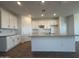 A kitchen with white cabinets, granite countertops, stainless steel appliances, and a large island at 4521 S 95Th Dr, Tolleson, AZ 85353