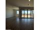 Bright living room with tile flooring and large sliding glass doors to the backyard at 4521 S 95Th Dr, Tolleson, AZ 85353