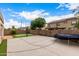 Recreational backyard featuring putting green, trampoline, and basketball court at 461 W Flamingo Dr, Chandler, AZ 85286