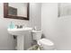 Bright powder room featuring pedestal sink, framed mirror, and toilet with modern bidet at 461 W Flamingo Dr, Chandler, AZ 85286