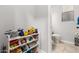 Cozy half bathroom with neutral tile and organized storage at 461 W Flamingo Dr, Chandler, AZ 85286