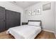 Bedroom with a grey accent closet door, hard wood flooring, and neutral decor at 461 W Flamingo Dr, Chandler, AZ 85286