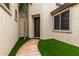 Inviting entryway with artificial turf, a stone walkway, and a stylish front door at 461 W Flamingo Dr, Chandler, AZ 85286