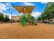 A colorful playground with slides and climbing equipment sits on a wood chip surface, inviting to play at 461 W Flamingo Dr, Chandler, AZ 85286