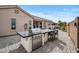 Outdoor kitchen featuring a large grill and bar seating, perfect for entertaining at 4960 E Villa Theresa Dr, Scottsdale, AZ 85254