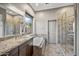 Bathroom featuring vanity with granite countertop, soaking tub, and glass shower enclosure at 4960 E Villa Theresa Dr, Scottsdale, AZ 85254