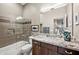 Well-lit bathroom with a granite countertop vanity and a shower over tub with glass screen at 4960 E Villa Theresa Dr, Scottsdale, AZ 85254
