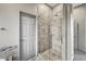 Bathroom showcasing a glass shower enclosure with tiled walls and flooring at 4960 E Villa Theresa Dr, Scottsdale, AZ 85254