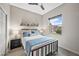 Bright bedroom with a queen bed, a ceiling fan, and view of the neighborhood at 4960 E Villa Theresa Dr, Scottsdale, AZ 85254