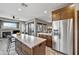 Open kitchen featuring an expansive island, stainless steel appliances, and seamless flow into the living area at 4960 E Villa Theresa Dr, Scottsdale, AZ 85254