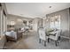 Open-concept living and dining area features neutral tones, plush seating, and stylish contemporary furnishings at 4960 E Villa Theresa Dr, Scottsdale, AZ 85254