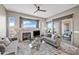 Comfortable living room with a fireplace, tile floors, and plenty of natural light at 4960 E Villa Theresa Dr, Scottsdale, AZ 85254