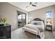 Relaxing bedroom featuring a king bed, patio access, and sunny windows at 4960 E Villa Theresa Dr, Scottsdale, AZ 85254
