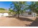 Large backyard featuring a shed, mature trees, and a covered patio providing outdoor living space at 510 W 14Th St, Tempe, AZ 85281