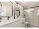 Bathroom features a dual sink vanity with modern fixtures and a glass enclosed shower with marble look tile at 510 W 14Th St, Tempe, AZ 85281