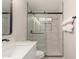 Modern bathroom featuring a glass enclosed shower with marble tile surround, a white vanity, and matte black hardware at 510 W 14Th St, Tempe, AZ 85281