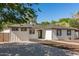 Well-maintained single-story home with clean lines, contrasted by lush trees, creating a serene outdoor setting at 510 W 14Th St, Tempe, AZ 85281