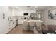 Modern kitchen features white cabinets, stainless appliances, quartz counters, and a center island with seating at 510 W 14Th St, Tempe, AZ 85281