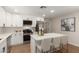Modern kitchen features white cabinets, stainless appliances, quartz counters, and a center island with seating at 510 W 14Th St, Tempe, AZ 85281