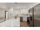 Modern kitchen featuring white cabinets, quartz counters, stainless appliances, and a center island with barstool seating at 510 W 14Th St, Tempe, AZ 85281