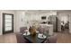 Bright kitchen boasts white cabinets, quartz counters, stainless appliances, and a center island with barstool seating at 510 W 14Th St, Tempe, AZ 85281