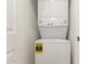 Efficient laundry area featuring a stacked washer and dryer unit, maximizing space in a compact design at 510 W 14Th St, Tempe, AZ 85281